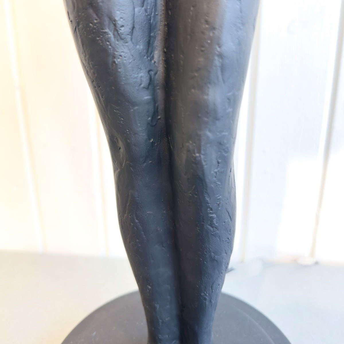Abstract table lamp of two intertwined legs on a round base