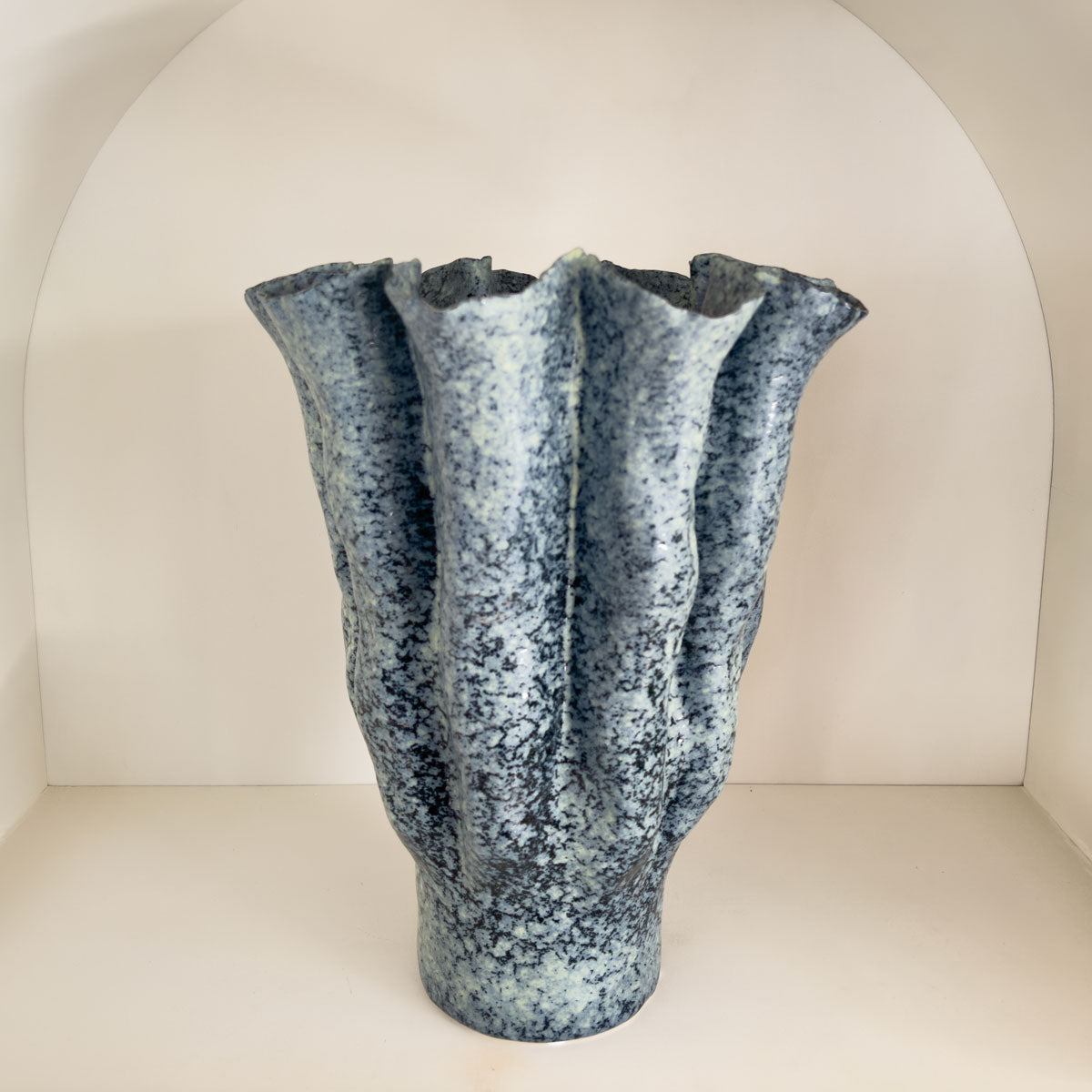 Textured blue vase on a white background