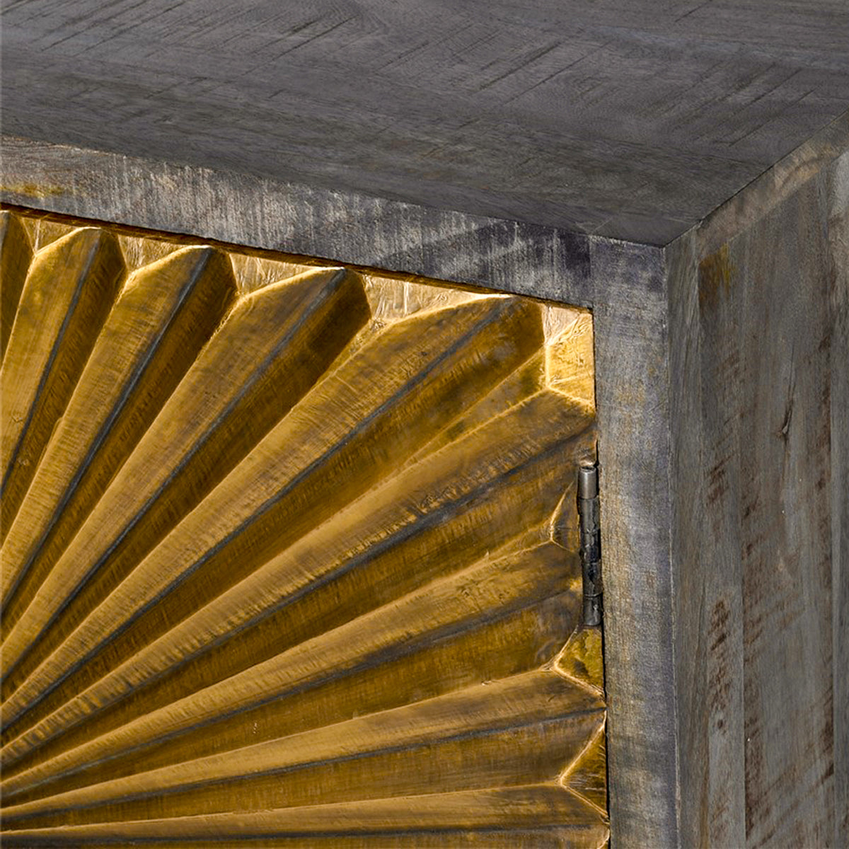 Close-up of a decorative canomet with gold starburst pattern and wood finish.