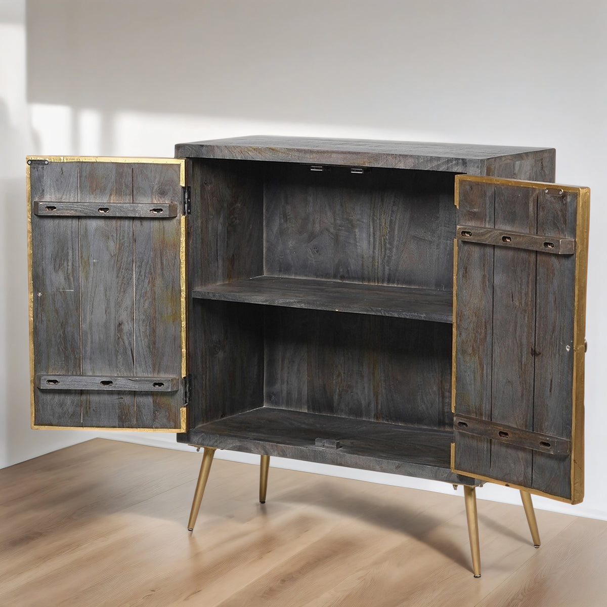 Wooden cabinet with gold accents on a wooden floor