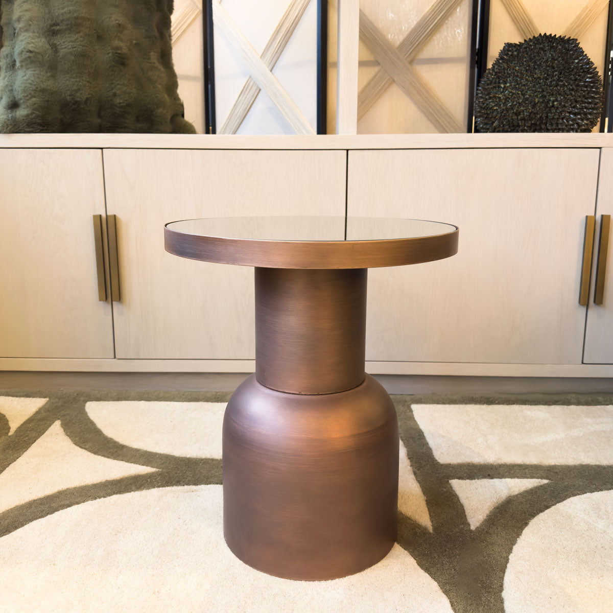 Bronze side table in a room with decorative elements