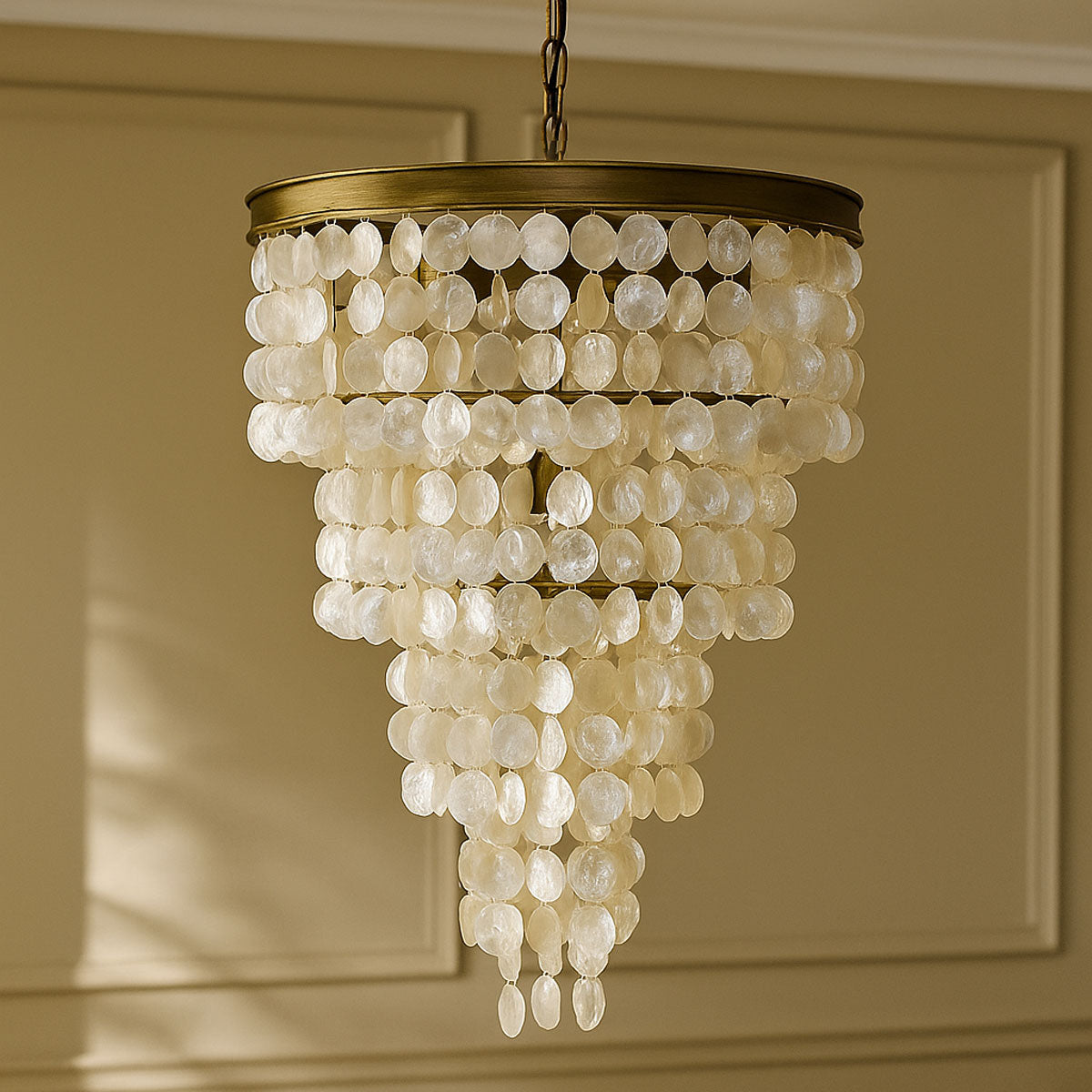 Decorative chandelier with white capiz beads against a beige wall