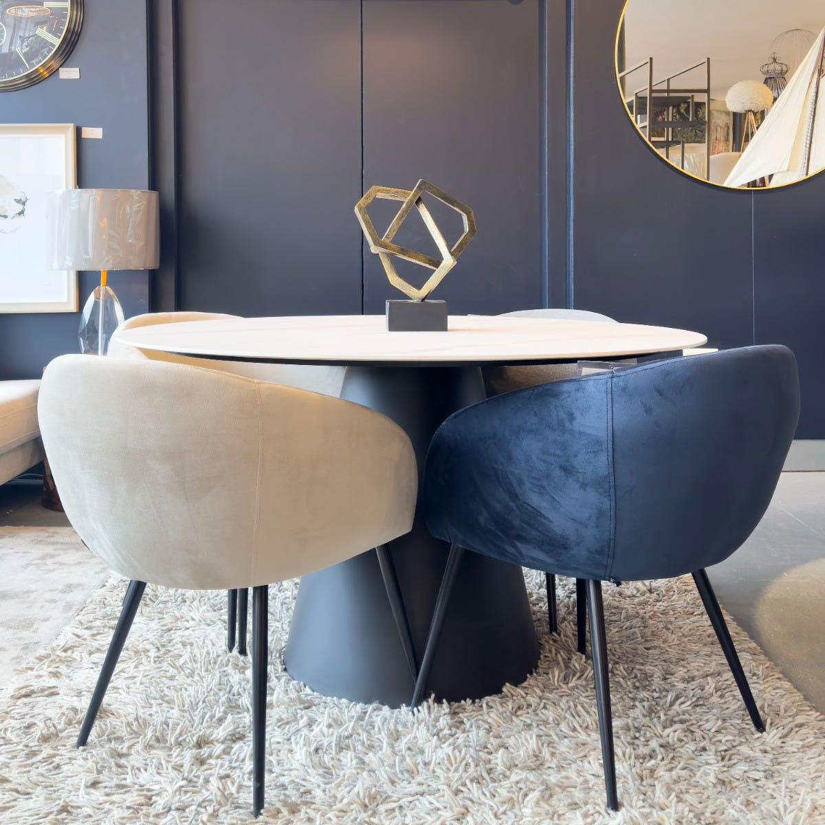 Modern dining set with round table and chairs in a stylish room.
