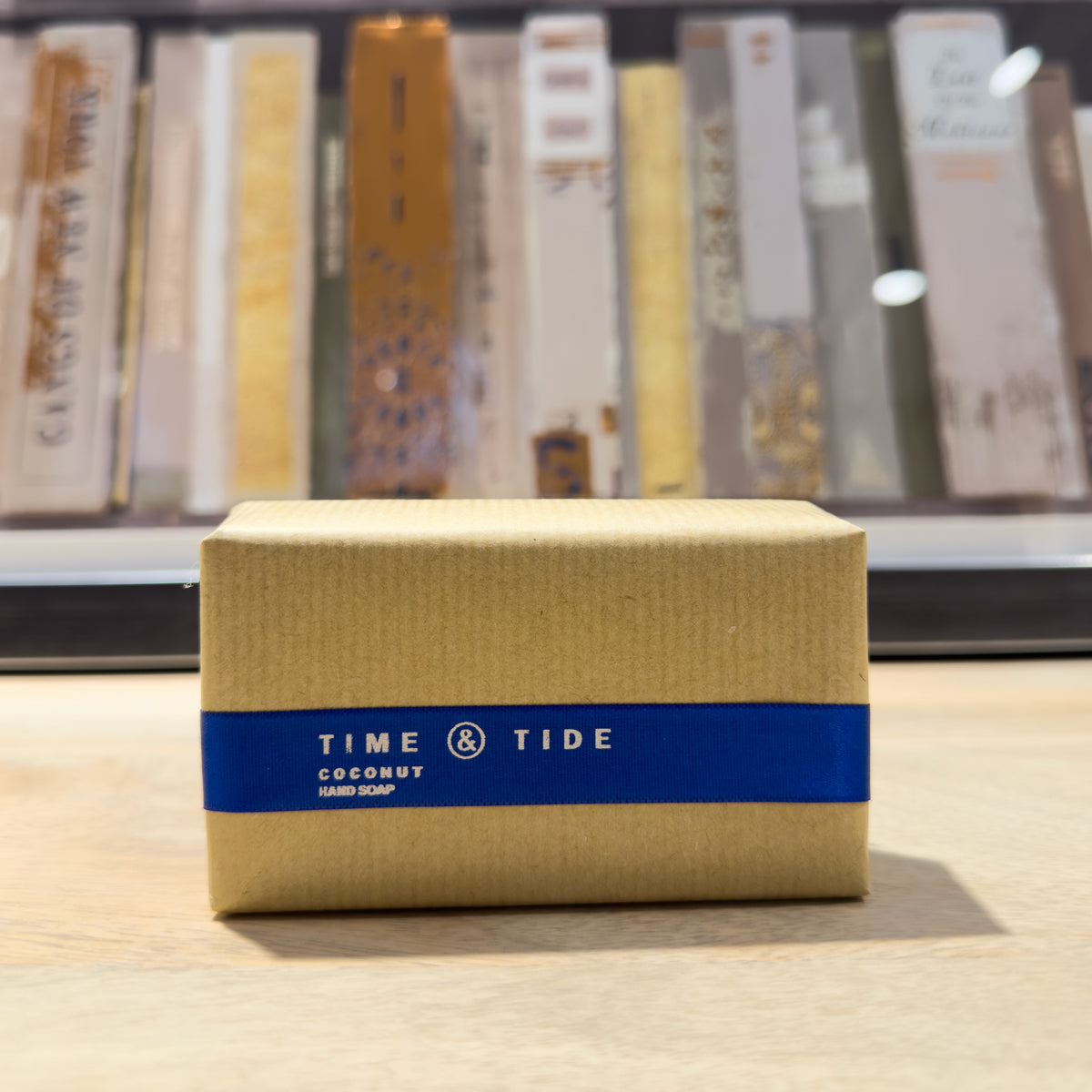 Box of Time & Tide coconut soap on a wooden surface with books in the background
