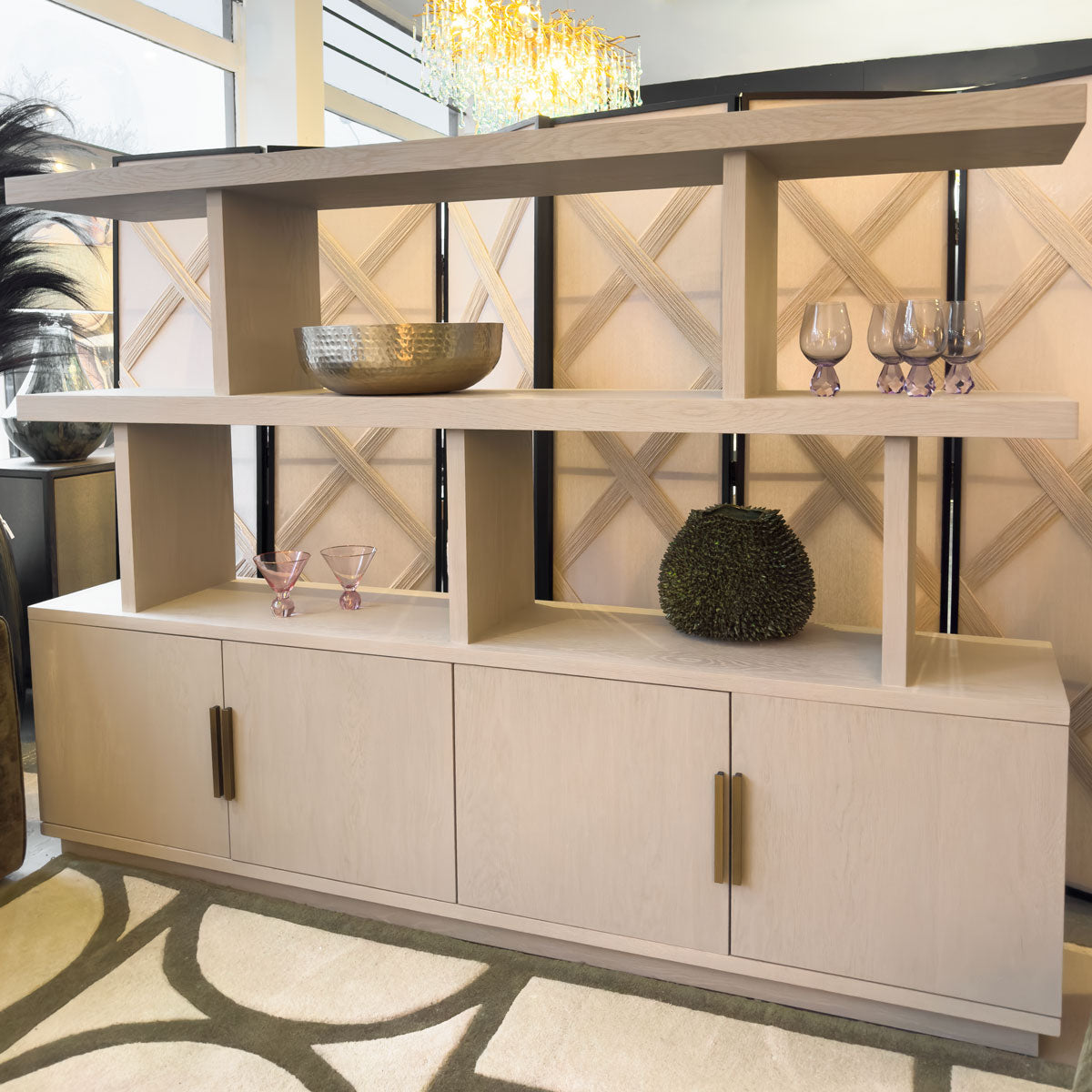 Modern light wood entertainment console with decorative items in a stylish room.