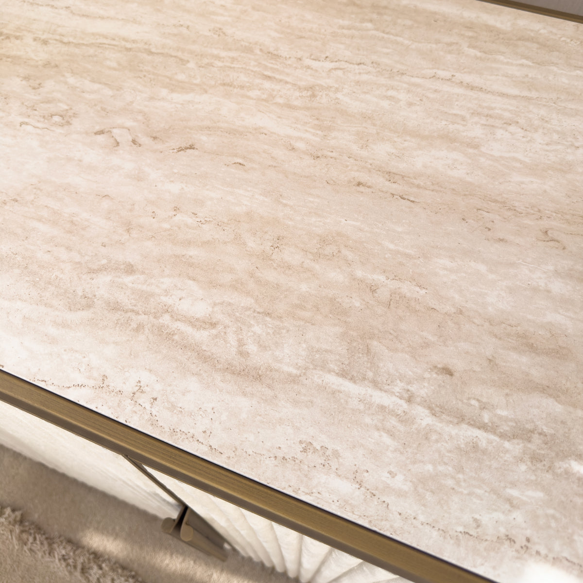 A close up of a sideboard table top in cream stone effect ceramic.