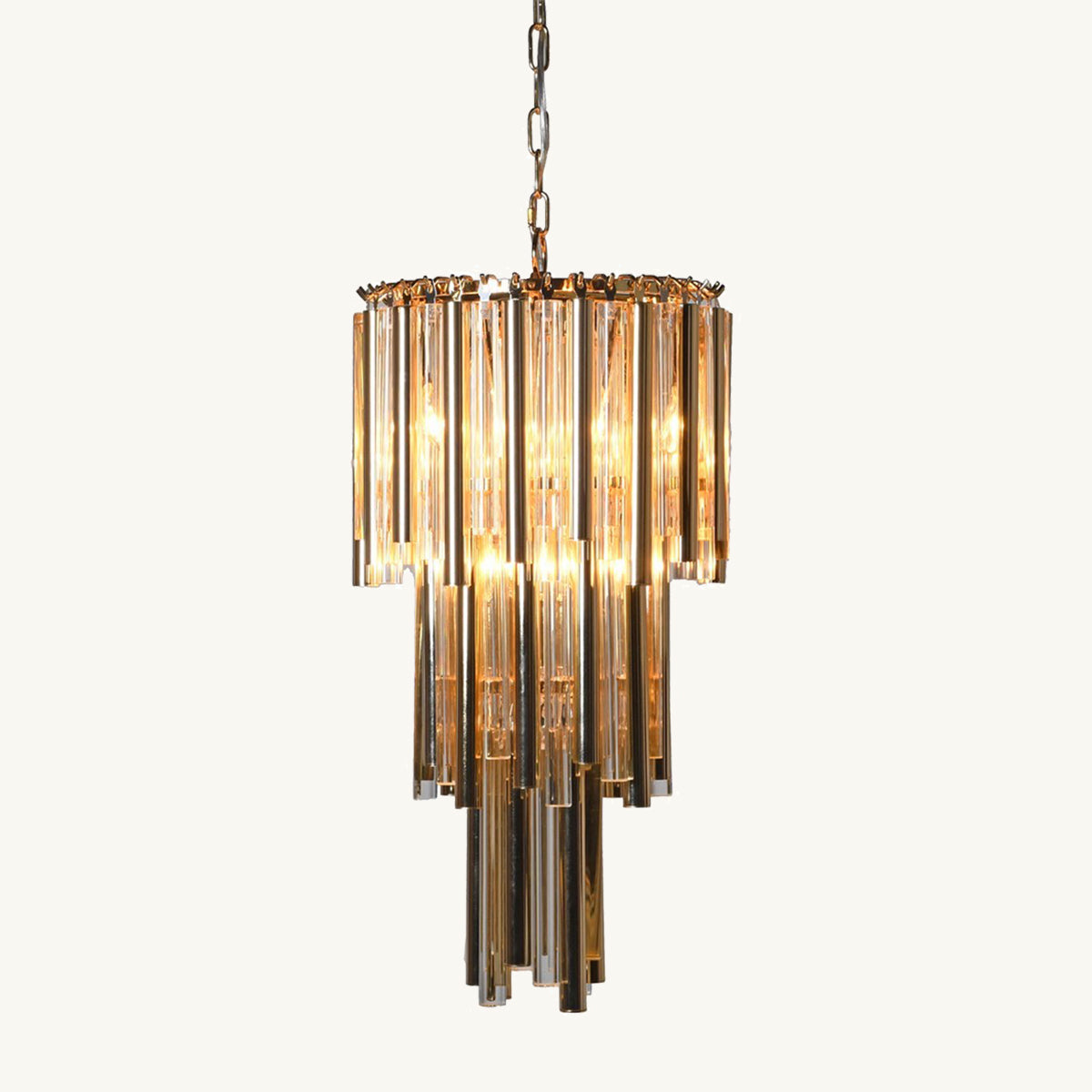 A deep gold tiered crystal chandelier with a tiered design hanging from a chain, with transparent glass elements.