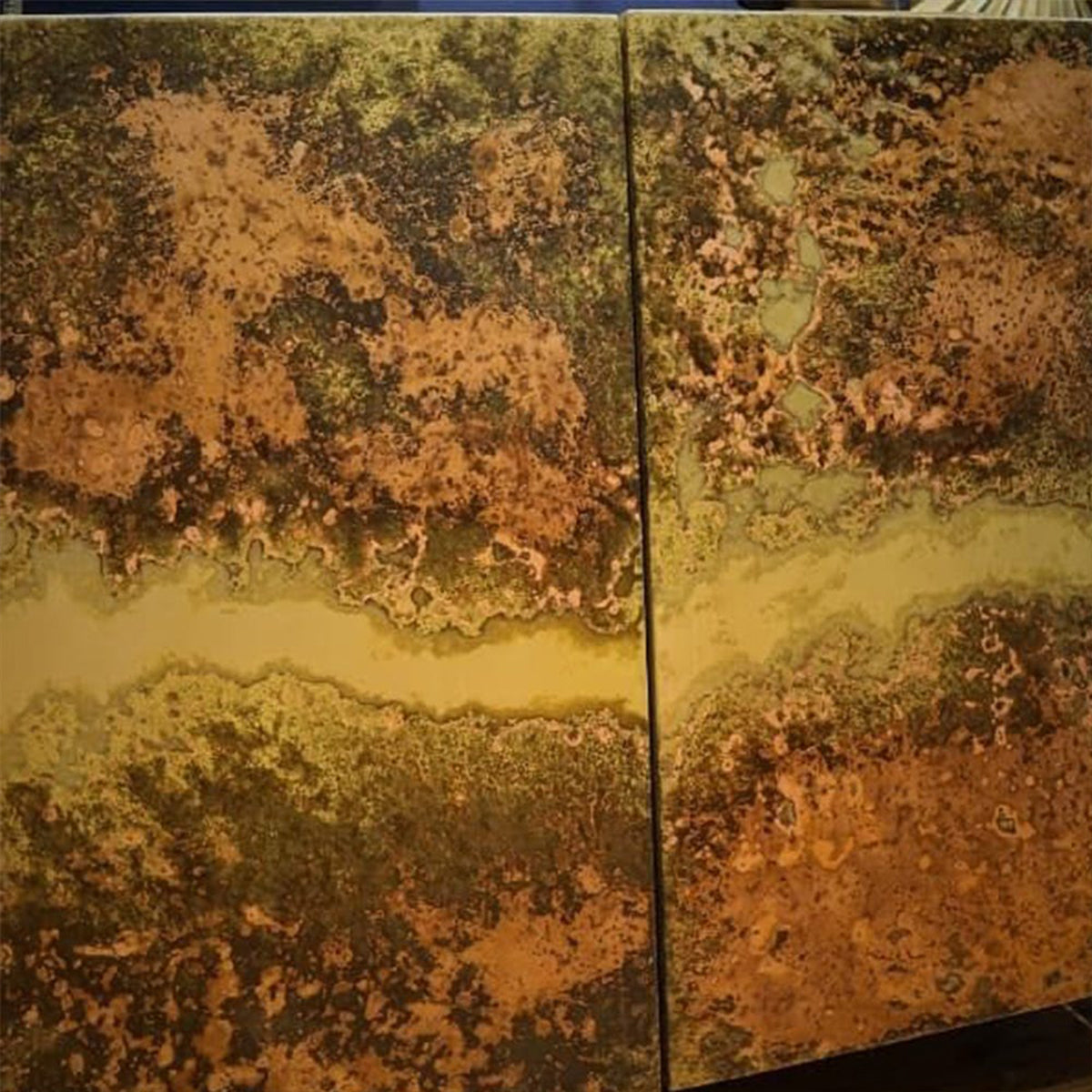 Two distressed iron sideboard doors with a textured, multicolored surface