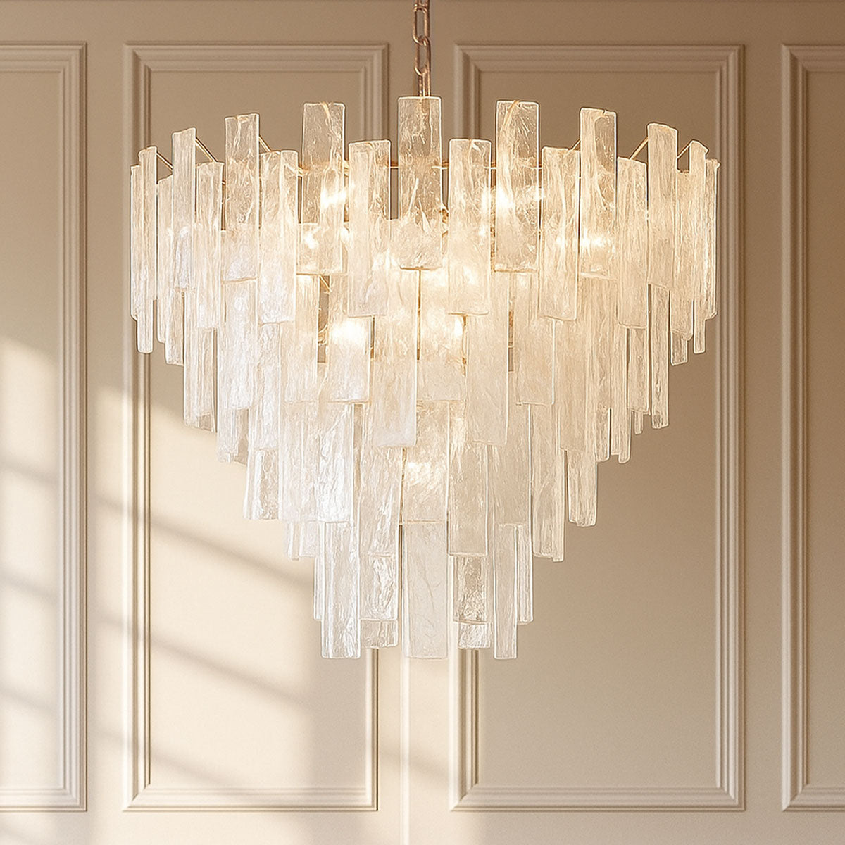 Chandelier with clear glass panels on a beige wall