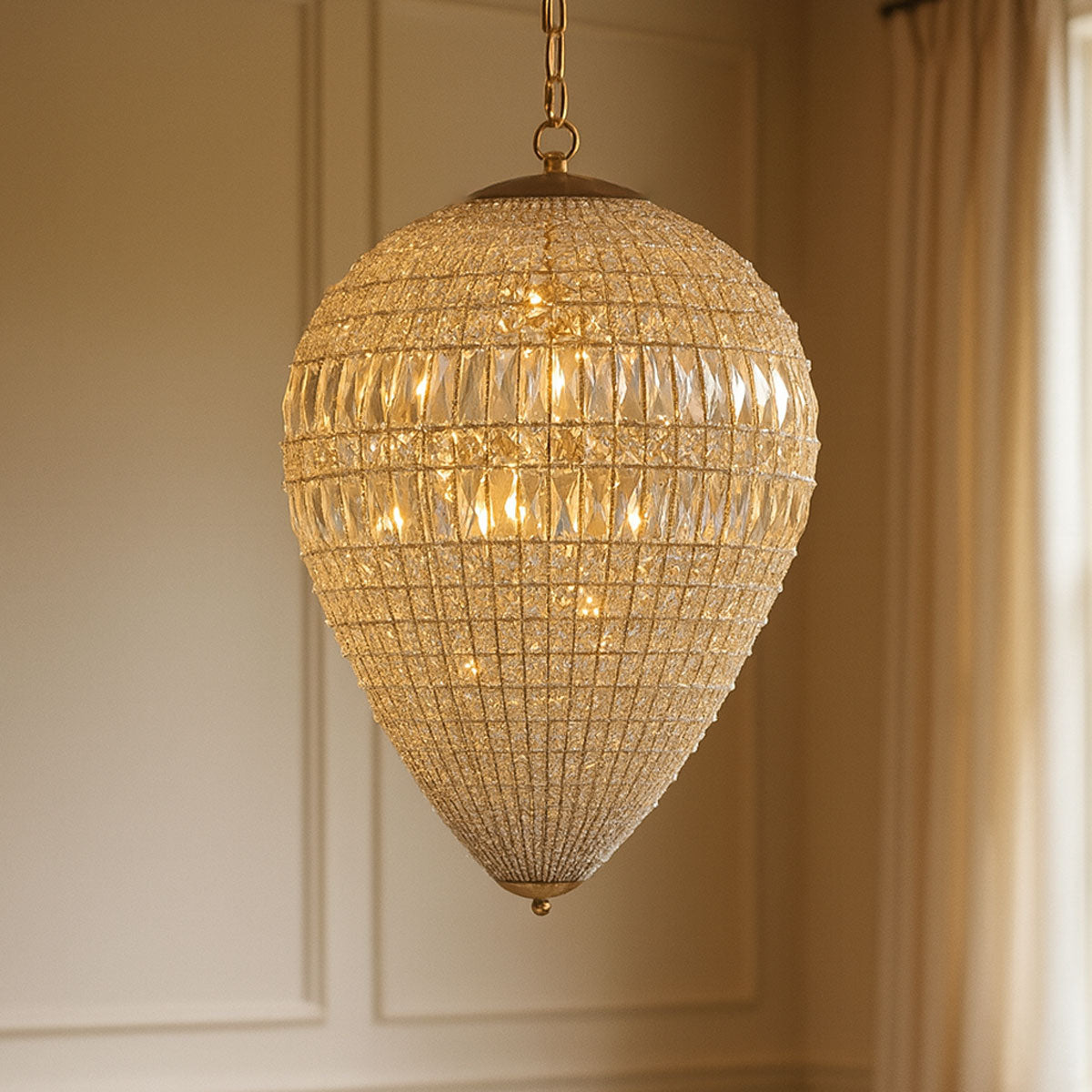 Gold chandelier hanging against a neutral wall