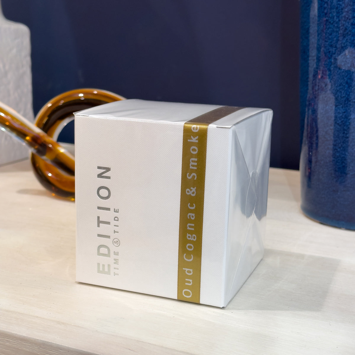 White box with gold accents labeled 'Edition Time & Tide' on a wooden surface.
