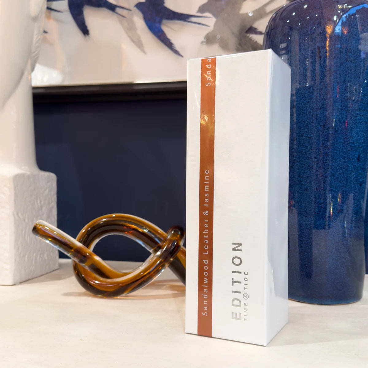 Sandalwood Leather & Jasmine Edition box with a decorative brown object on a shelf.