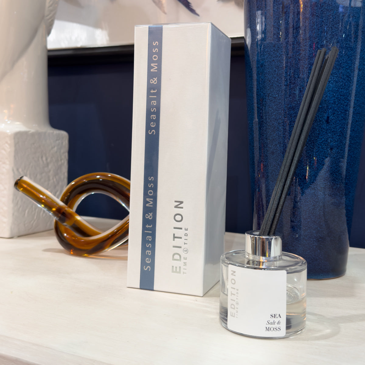 Seasalt & Moss diffuser with packaging on a decorative surface