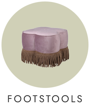 Purple footstool with fringe on a light green background