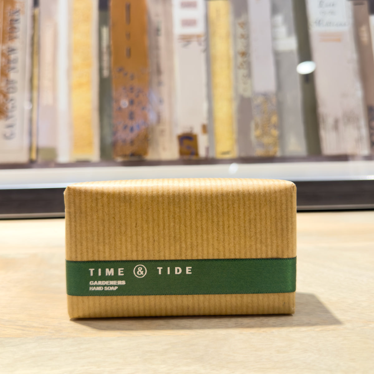 Bar of soap with 'Time & Tide' branding on a wooden surface.