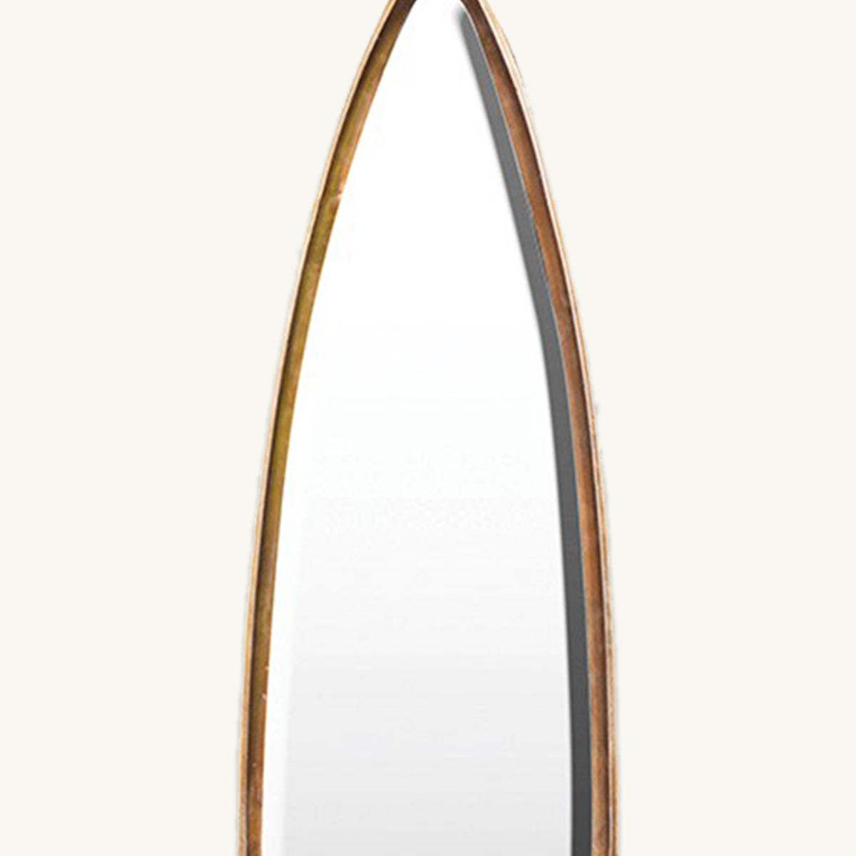 A close up of a narrow pointed mirror with a bright gold narrow frame.
