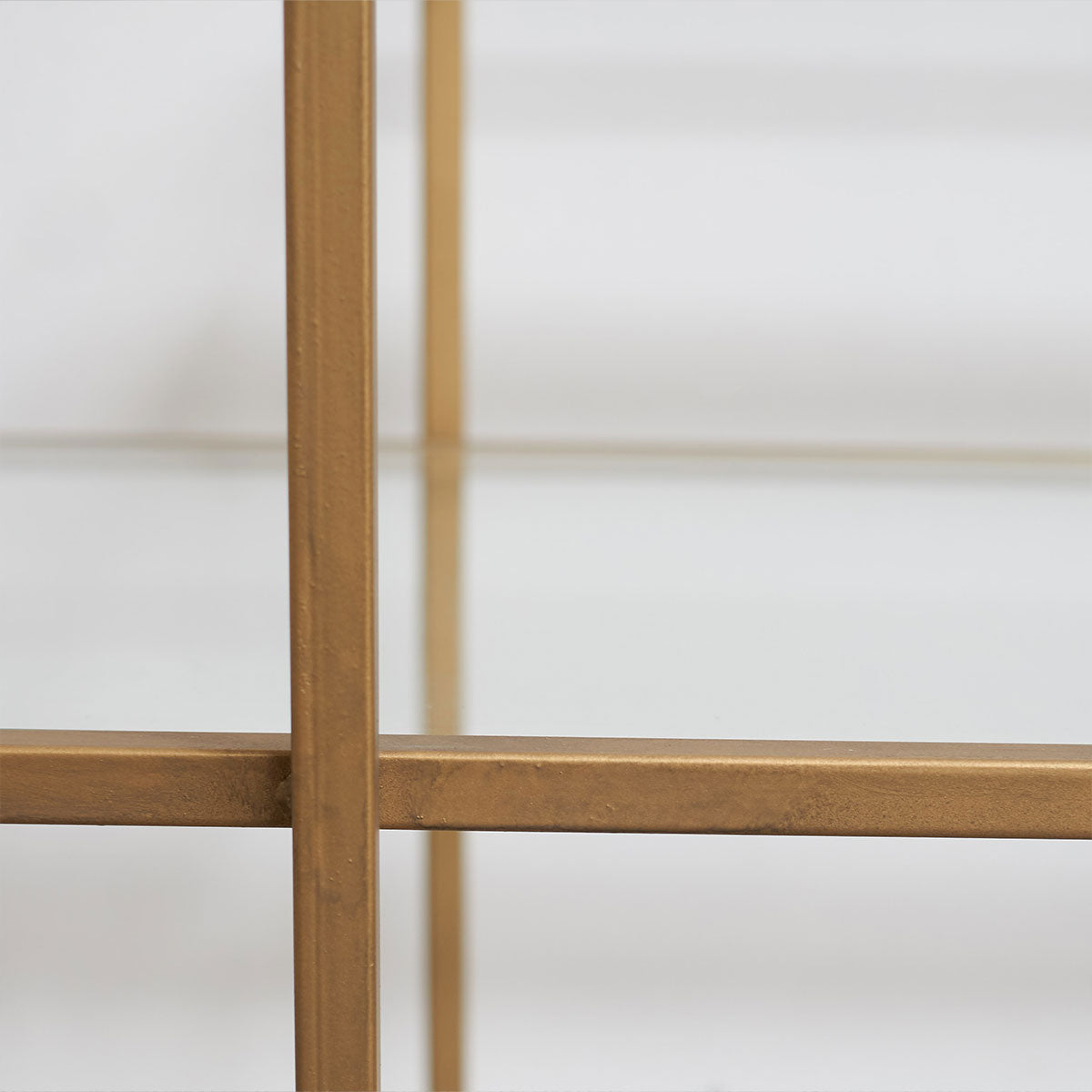 Gold shelf structure against a white background