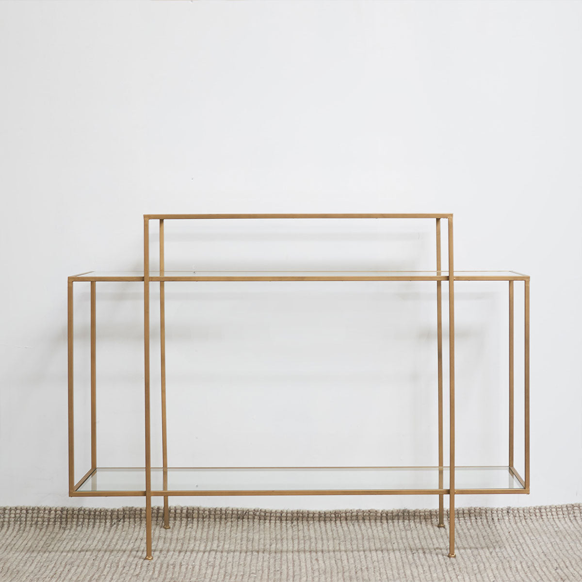 Gold metal console table on a white background