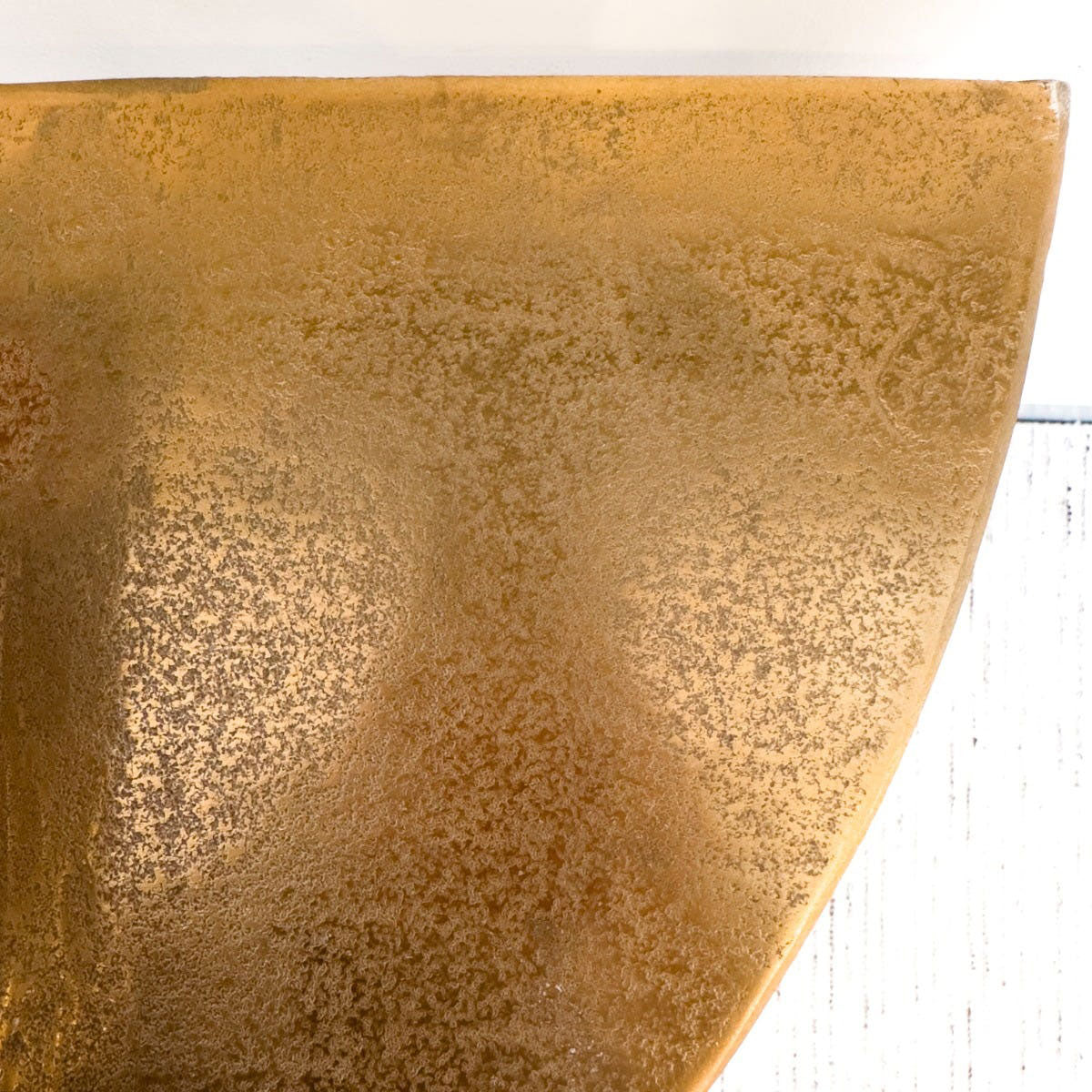 Close-up of a textured gold surface on a white background