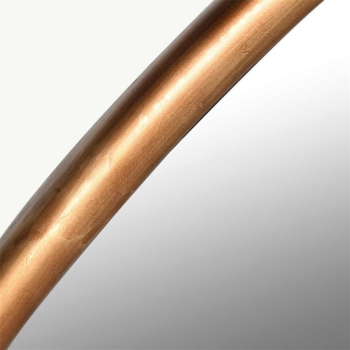 A close up of a gold frame mirror, showing the distressed details of the frame.