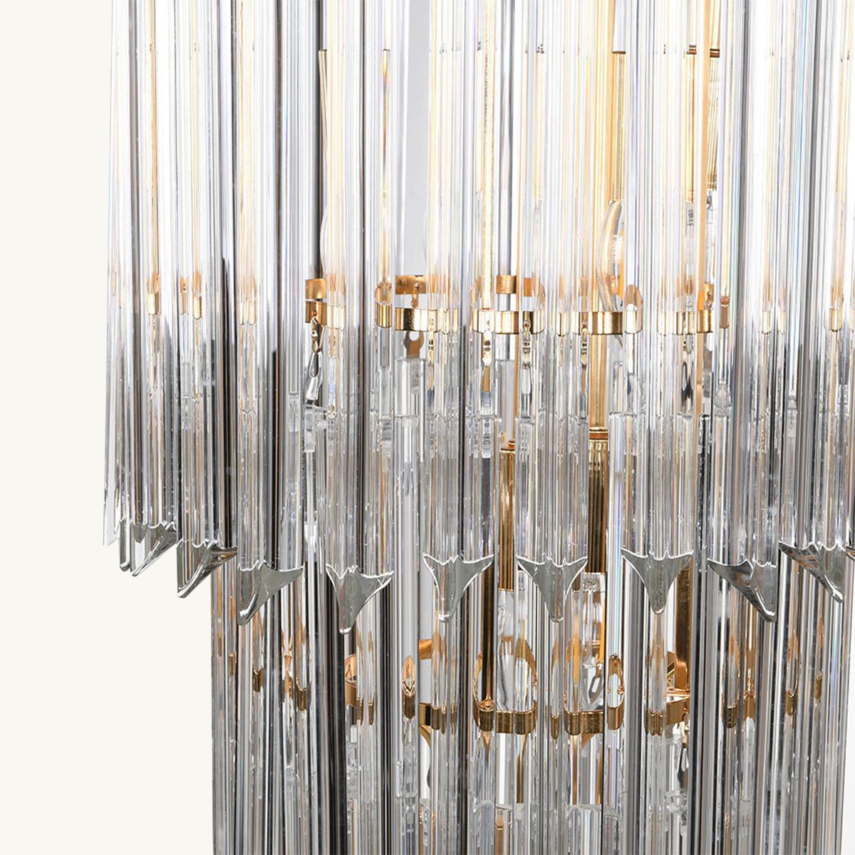 Chandelier with clear glass rods and gold accents on a white background