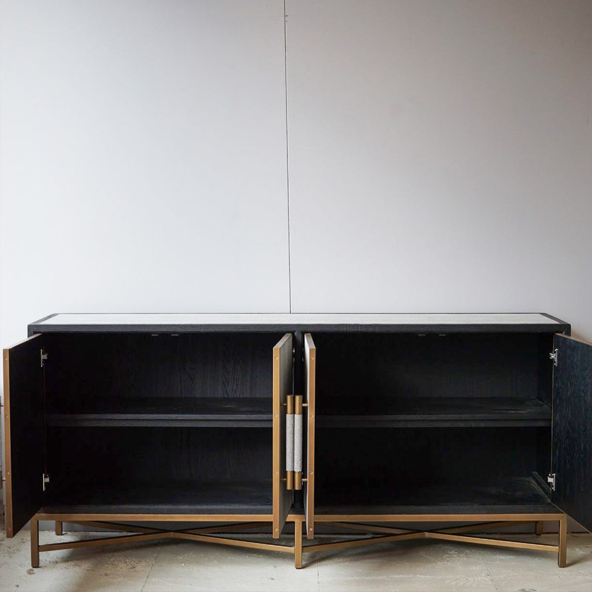 Black cabinet with gold accents on a white background