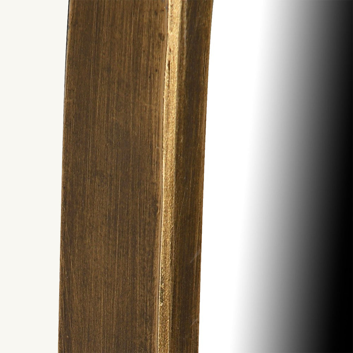 A mirror with a narrow brushed gold painted frame.