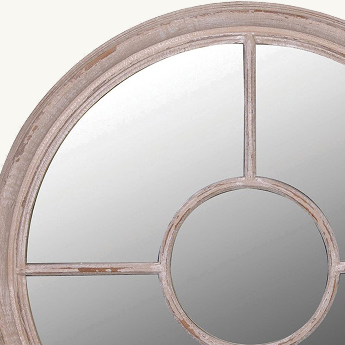 A close up of a distressed wood circular mirror with window pane details.