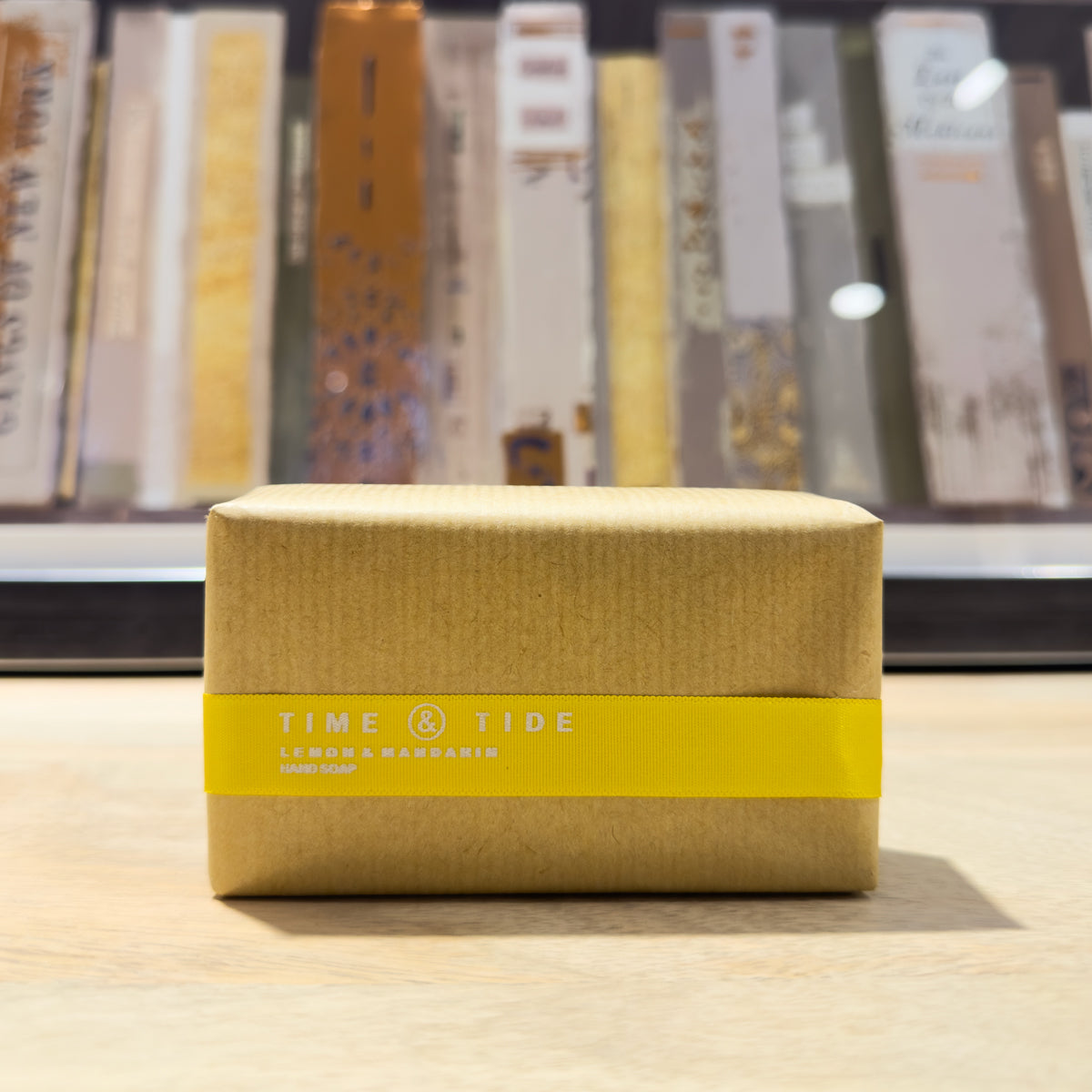 Lemon soap bar with a yellow label on a wooden surface
