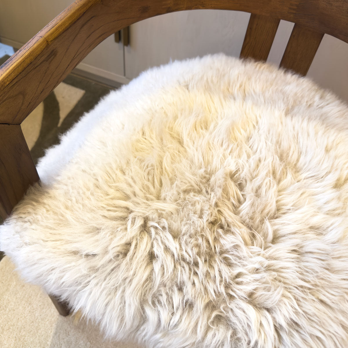 An oak and sheepskin furry dining chair