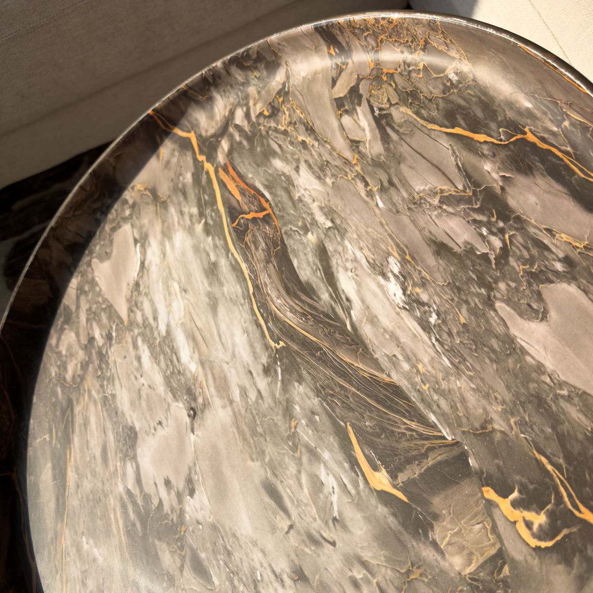 Round marble table with brown and gold veining