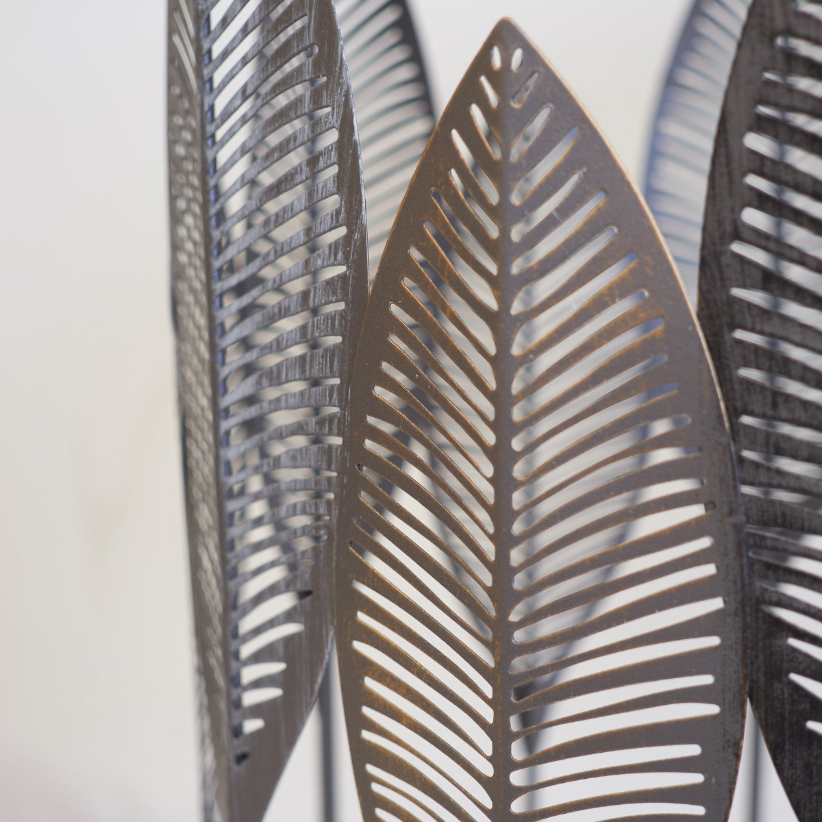 Decorative side table with leaf-shaped cutouts on a white background