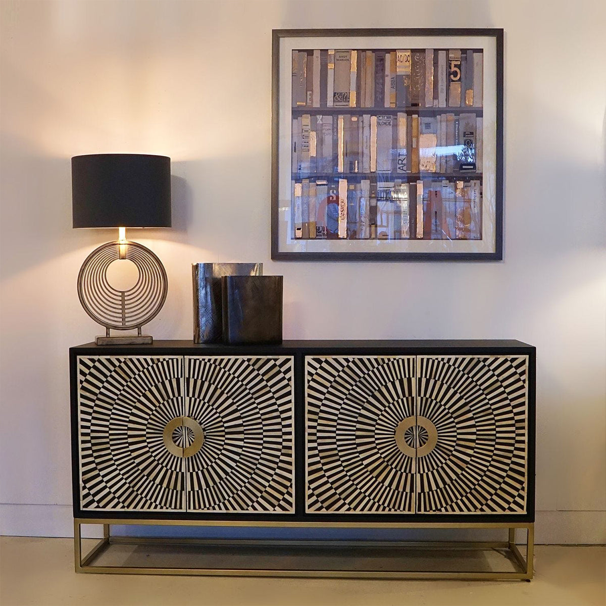 Decorative bone inlay sideboard with geometric patterns, lamp, and framed artwork in a room.
