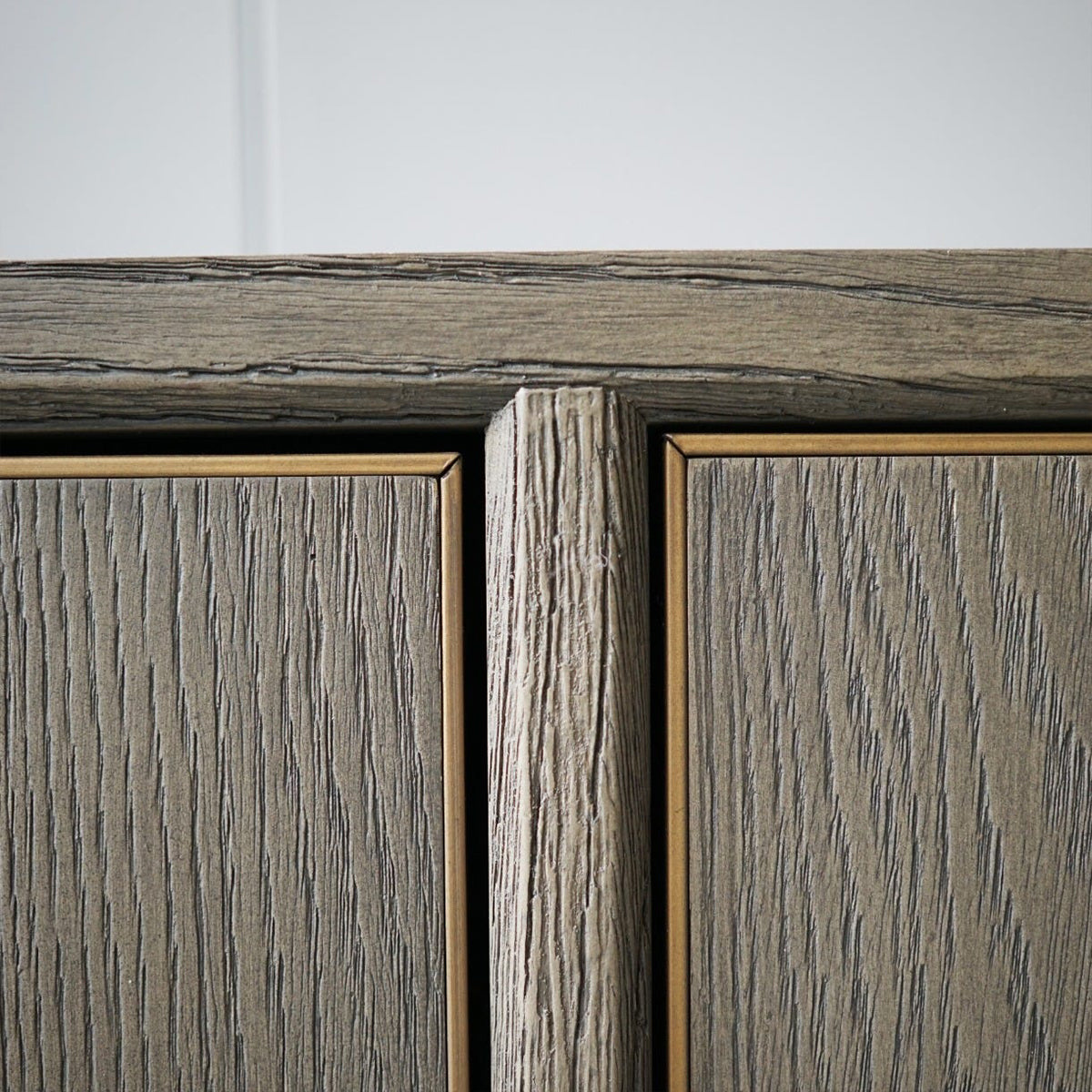 Close-up of a grey parquet sideboard with a focus on texture and grain.