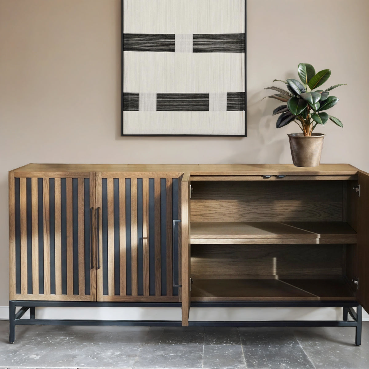 Wooden cabinet with open door, plant, and abstract art on wall