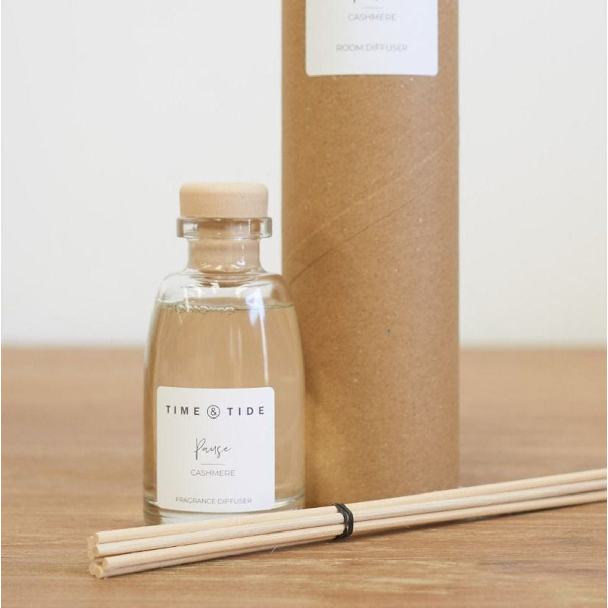 Time & Tide fragrance diffuser bottle with reeds and cardboard box on a wooden surface