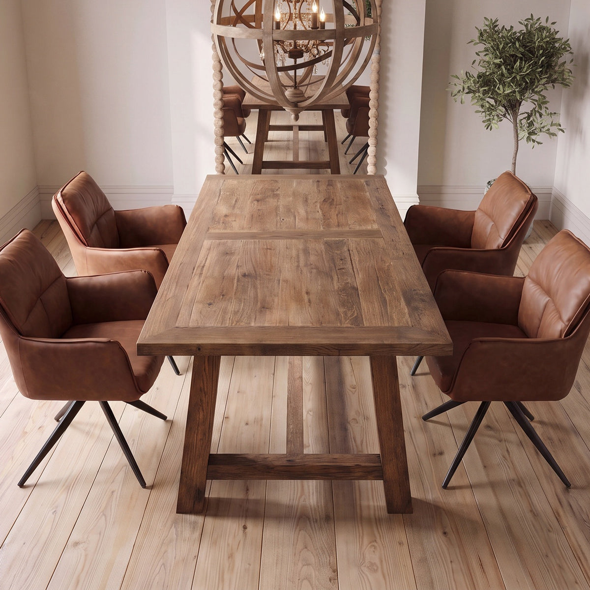 A rustic rectangular wooden dining table surrounded by four brown leather swivel chairs with black metal legs, set in a bright dining room with light wood floors and a decorative globe chandelier in the background.