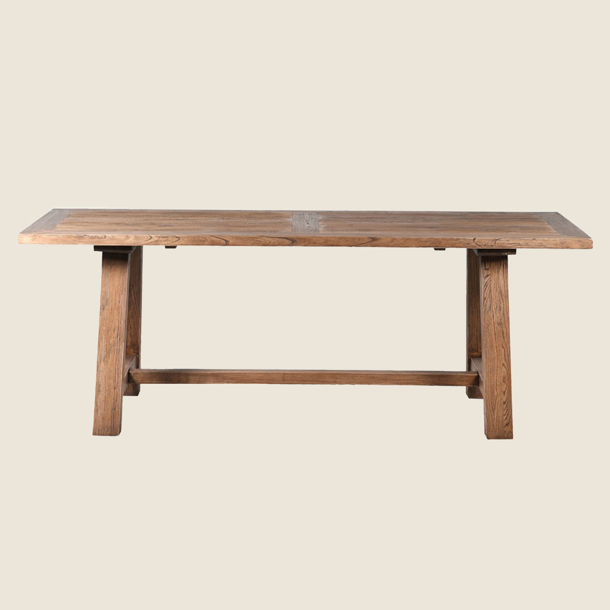 A rustic wooden dining table with a rectangular top, two angled legs, and a central stretcher bar, shown against a solid light beige background.