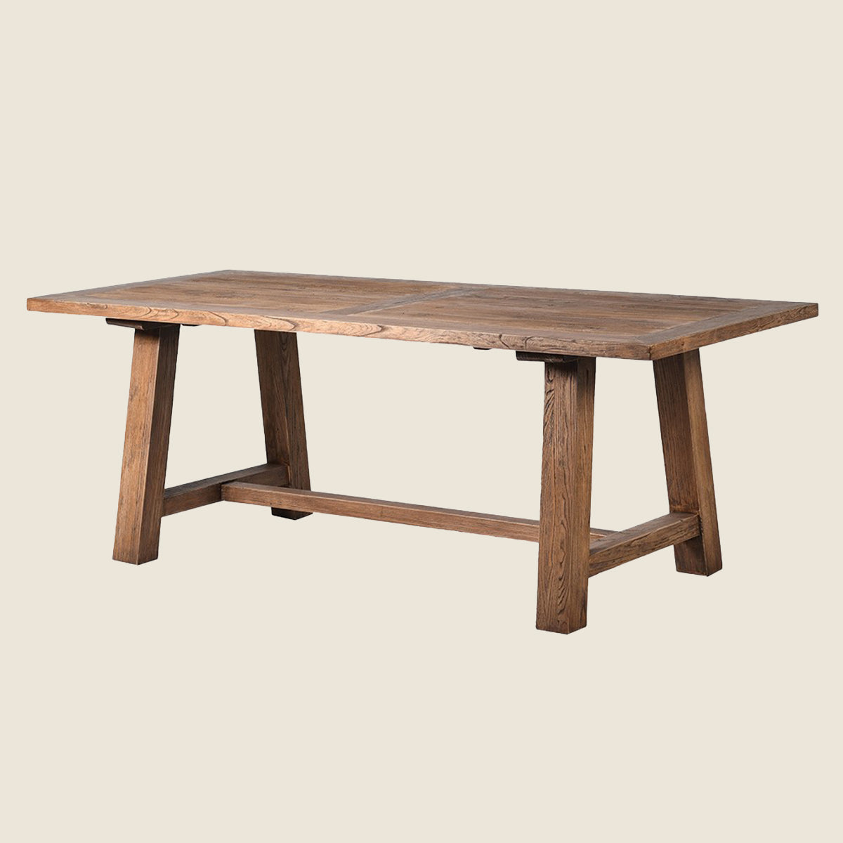 A rustic rectangular wooden dining table with a warm medium-brown finish, featuring thick A-frame legs and a lower support rail, shown against a solid light beige background.