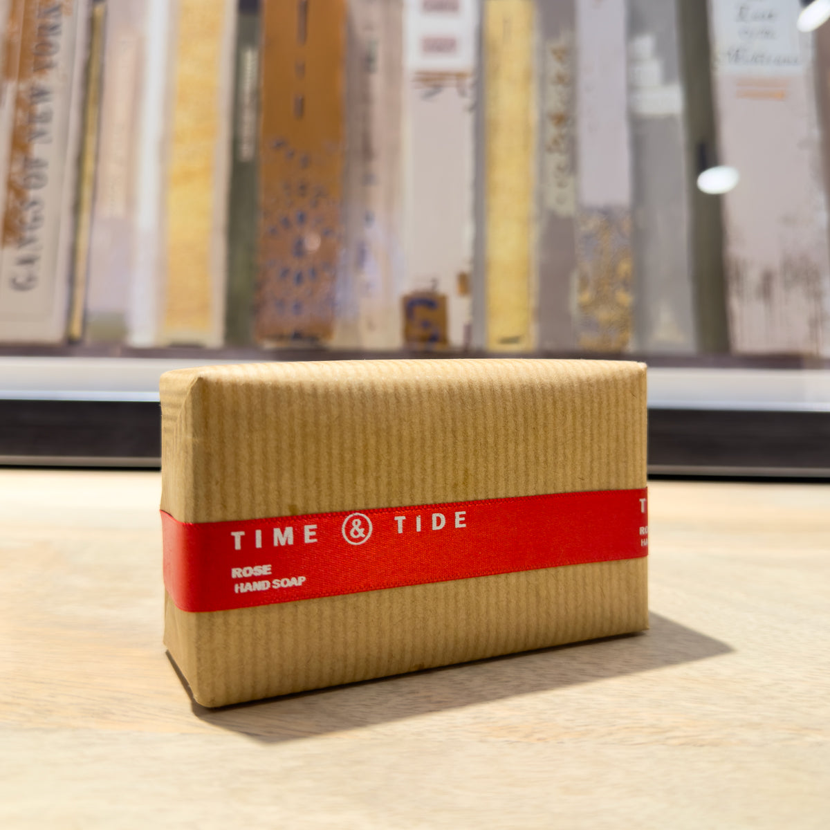 Time & Tide rose soap bar with a red label on a wooden surface