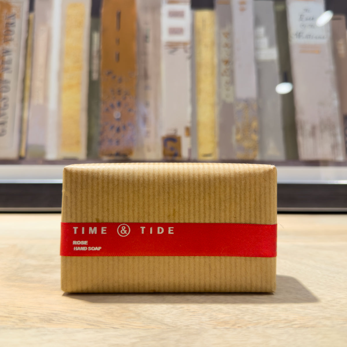 Rectangular soap bar with 'Time & Tide' branding on a wooden surface.