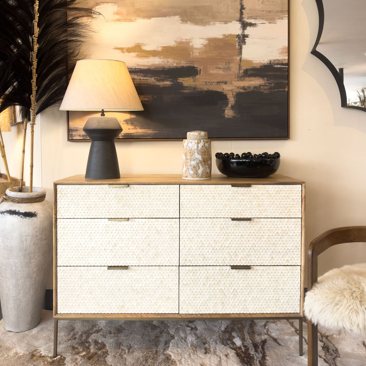 Modern dresser with decorative items in a stylish room setting