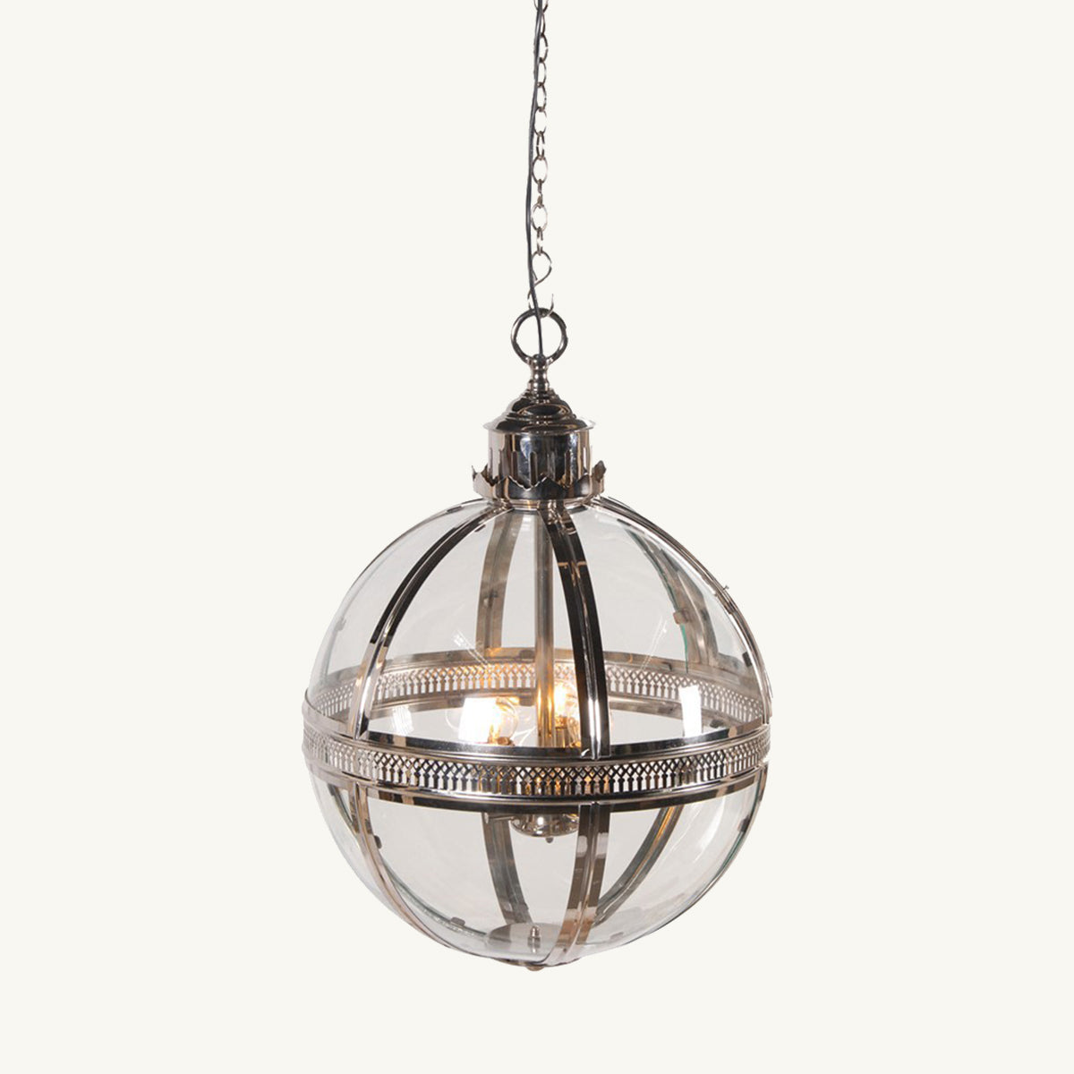 A silver and glass ball shaped ceiling pendant with carvings along the metalwork.