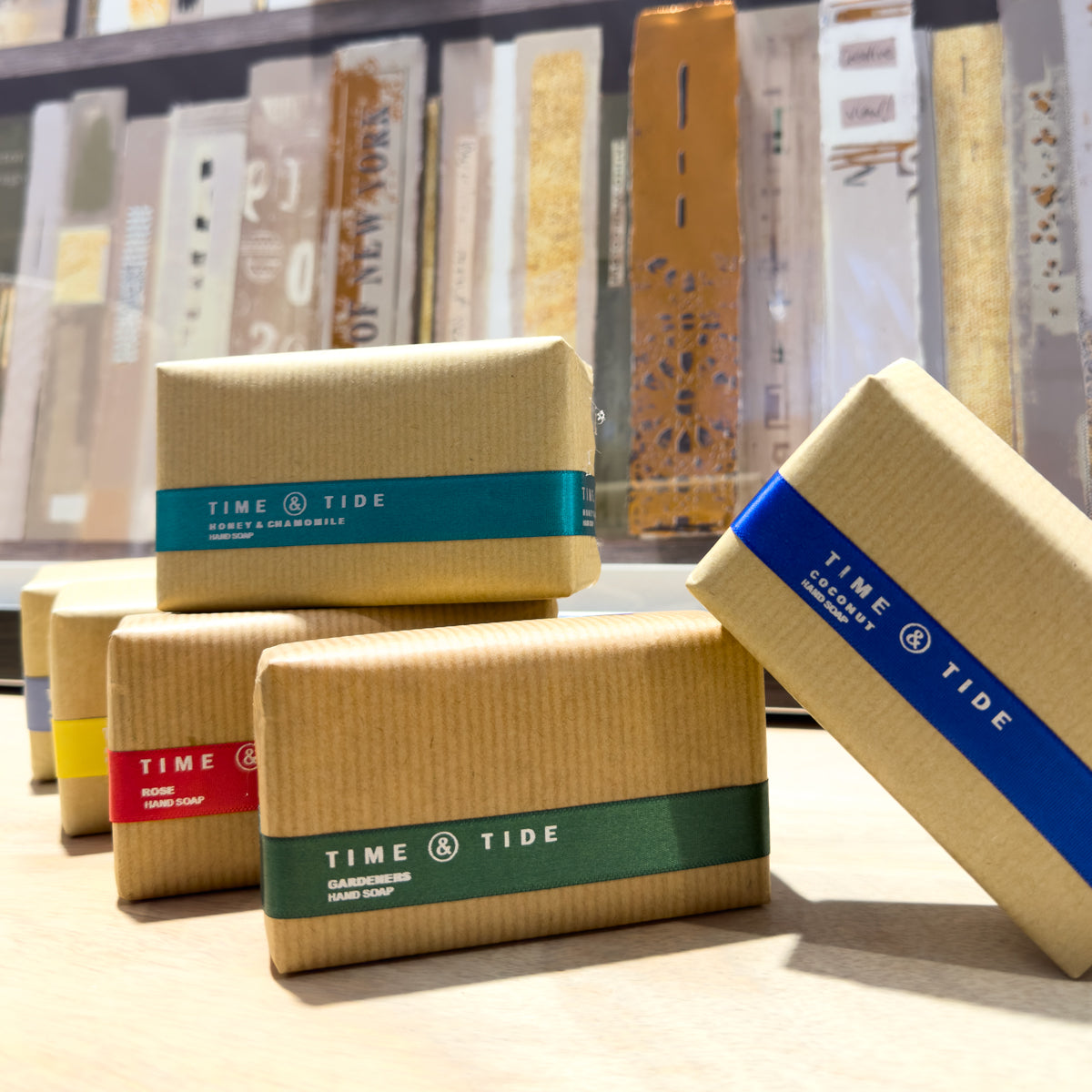 Time & Tide soap bars with colorful labels on a sideboard surface.