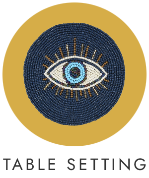 Decorative coaster with eye design on a yellow circle, labeled 'Table Setting'.