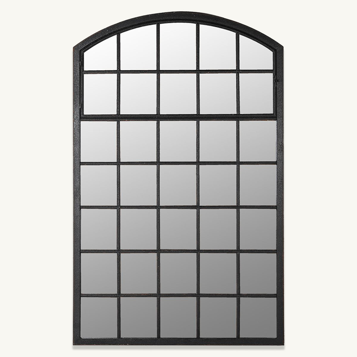 A panelled arch mirror with black distressed grid details on the mirrored glass.