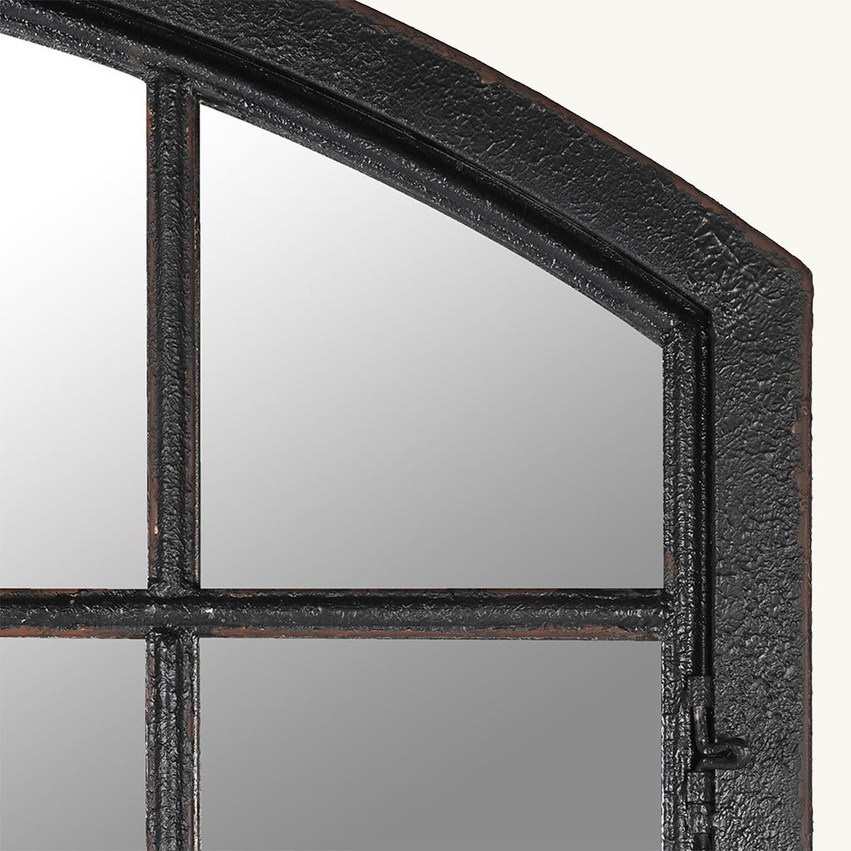 A close up of a distressed iron arched frame mirror in black.