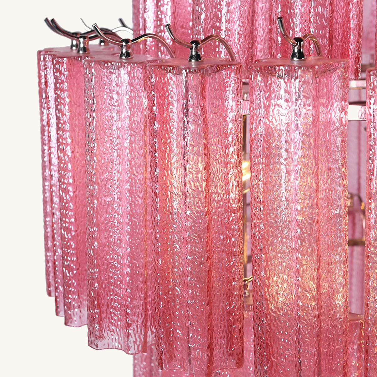 Pink chandelier with metallic fixtures on a white background