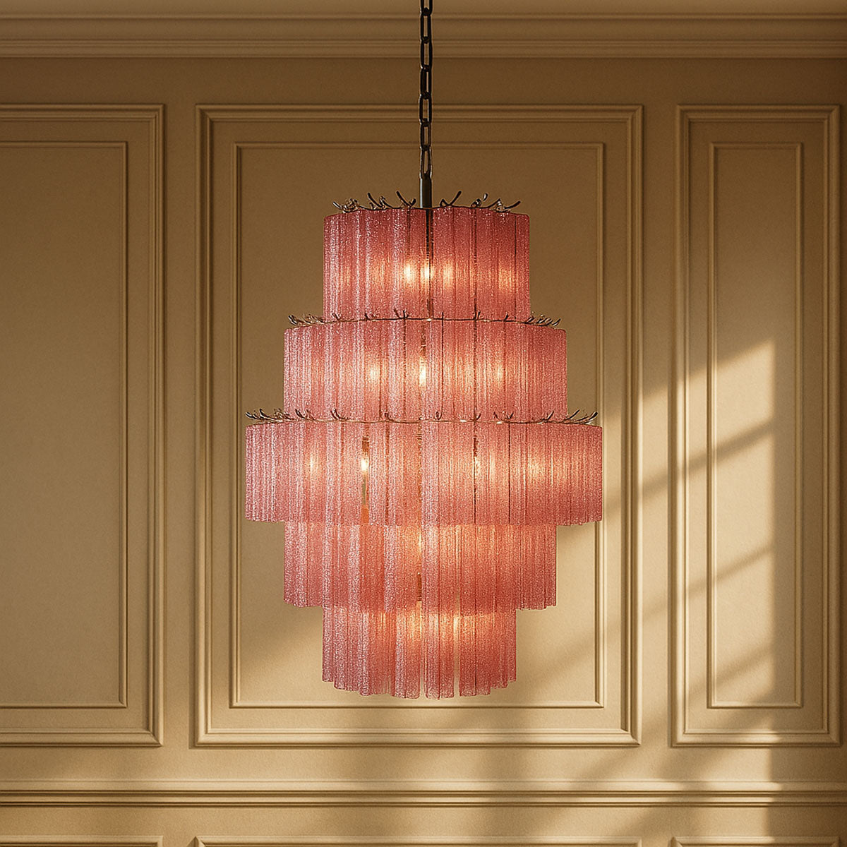 Pink chandelier hanging against a beige paneled wall