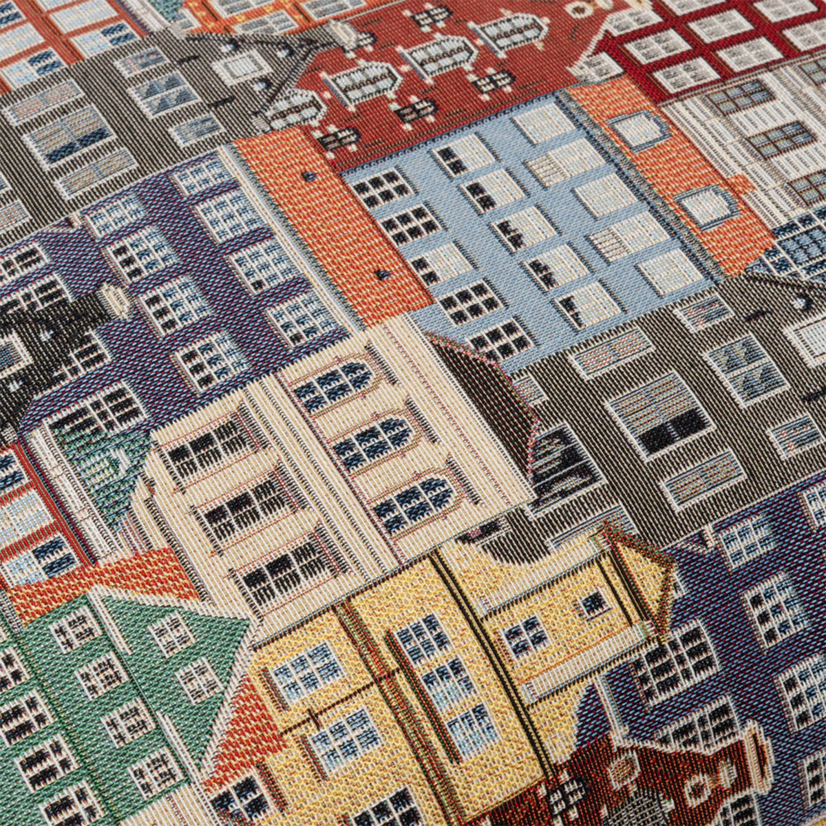 Close-up of a textured fabric with a pattern of buildings.